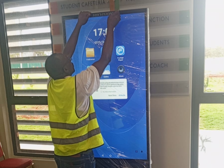 Technician labelling a advert stand