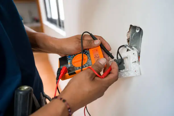 A photo of a electrician installing a socket