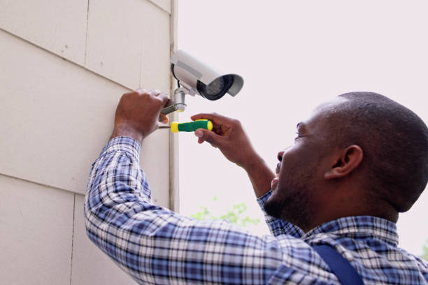Electrician installing CCTV cameras